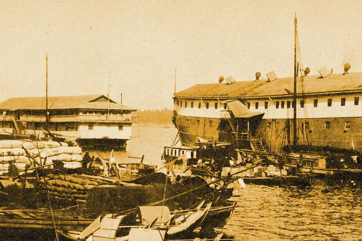 Illustration: Opium hulks in Shanghai Harbour, from a period photograph (1901), redrawn as a ochre blue pencil duotone.